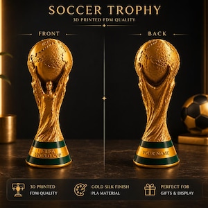May include: A gold-colored 3D printed soccer trophy with a silk finish, featuring a globe held by two figures. The front base displays the text FIFA WORLD CUP, while the back base shows the text YOUR NAME. The trophy has a green band at the base.
