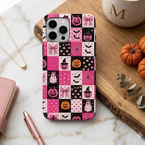 May include: A smartphone case featuring a checkered pattern of pink and black squares. The design includes various Halloween-themed icons such as jack-o'-lanterns, ghosts, bats, spiderwebs, and bows, interspersed with small heart and flower motifs.