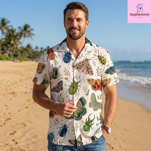 May include: A short-sleeved button-down shirt in off-white featuring a colorful all-over print of various insects, including beetles, moths, and butterflies, interspersed with small green sprigs and foliage patterns across the entire garment.