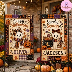 May include: Two rectangular garden flags featuring a cream background with a patchwork border of orange, purple, and black patterns. The left flag displays a ghost with a plaid bow and scarf holding a pumpkin bucket, labeled Happy Halloween and Olivia. The right flag shows a ghost with a plaid bow and scarf next to a cauldron, labeled Spooky Season and Jackson.