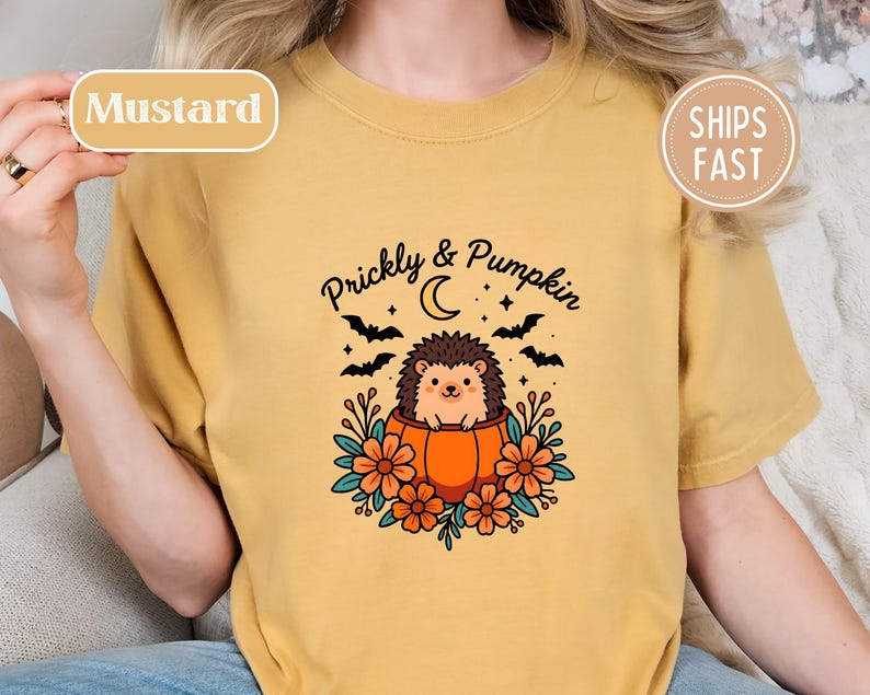 Mustard shirt with a cute hedgehog in a pumpkin and "Prickly & Pumpkin" text.