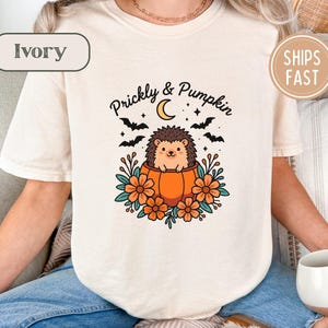 Ivory t-shirt with hedgehog in pumpkin graphic, text "Prickly & Pumpkin".