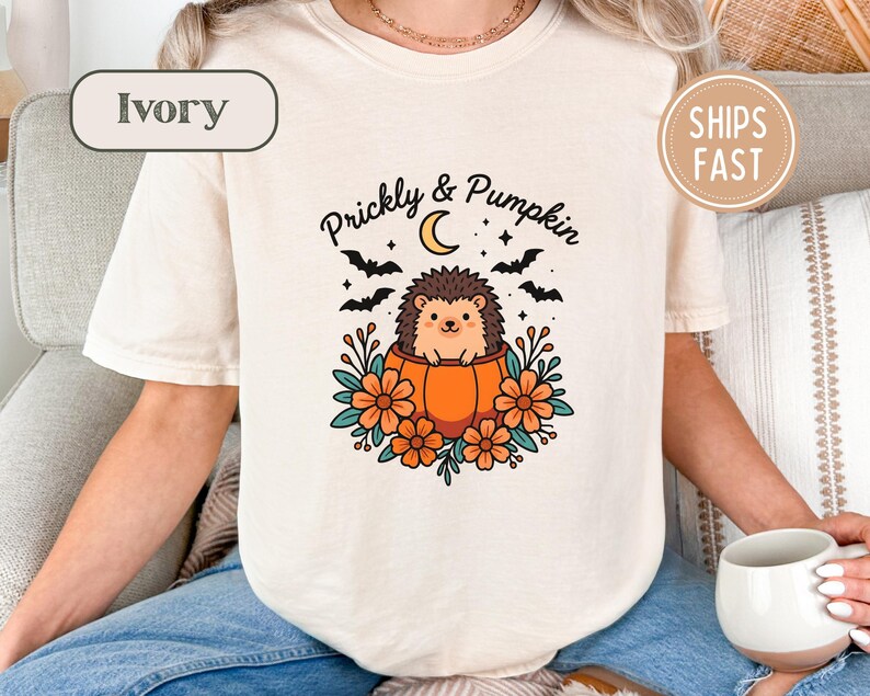 Ivory t-shirt with hedgehog in pumpkin graphic, text "Prickly & Pumpkin".