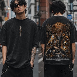 May include: A black acid-wash t-shirt featuring a small vertical lightning bolt graphic on the front and a large, detailed anime character illustration on the back, accompanied by Japanese kanji characters and English text at the bottom.
