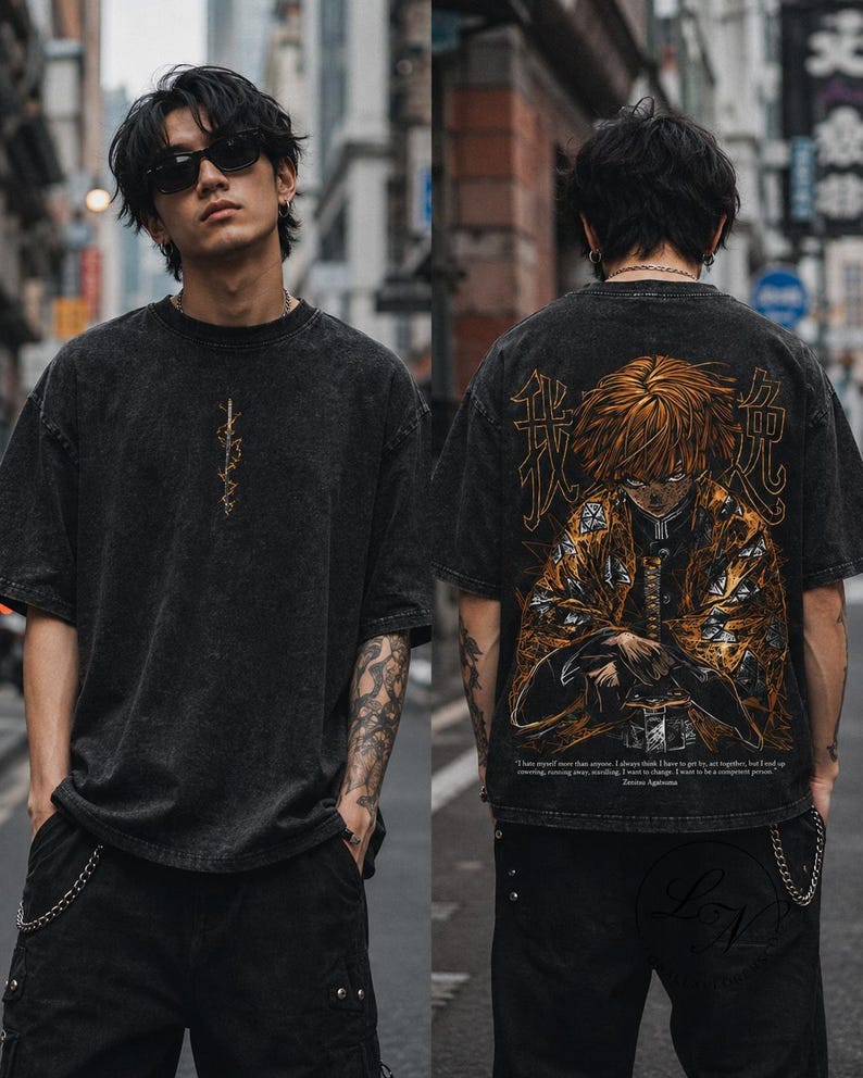 May include: A black acid-wash t-shirt featuring a small vertical lightning bolt graphic on the front and a large, detailed anime character illustration on the back, accompanied by Japanese kanji characters and English text at the bottom.