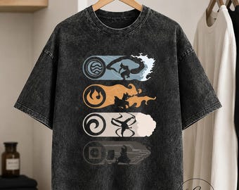 May include: A charcoal grey acid-wash t-shirt featuring a graphic print of four horizontal rectangular panels. Each panel displays a circular elemental symbol and a silhouette of a character performing martial arts moves representing water, fire, air, and earth.