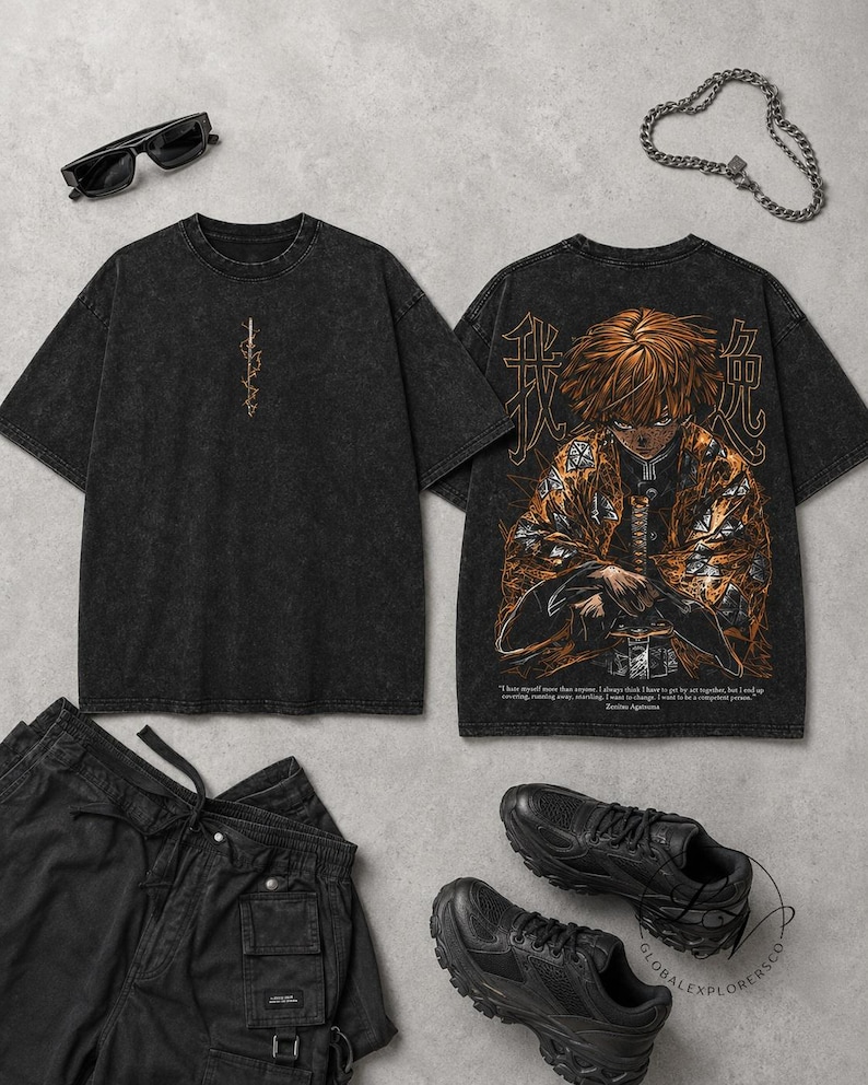 May include: A black acid-wash t-shirt featuring a small vertical graphic on the front and a large anime character illustration on the back with Japanese text. The set includes black cargo trousers, black trainers, sunglasses, and a silver chain necklace.
