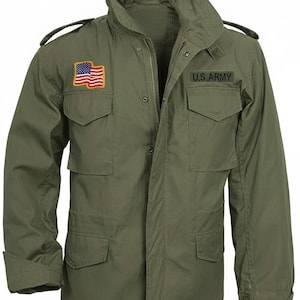 May include: An olive green field jacket featuring a high collar, shoulder epaulets, and four front pockets with buttoned flaps. The right chest displays a rectangular American flag patch, while the left chest features a black U.S. ARMY name tape.
