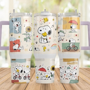 May include: A cream-coloured stainless steel tumbler with a light purple handle and lid, featuring a repeating pattern of Snoopy and Woodstock in various activities like cycling, holding a sunflower, and using an umbrella, accented by small colourful icons.