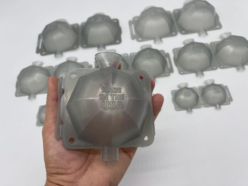 May include: A set of clear plastic molds for making ice spheres. The molds are shaped like a dodecahedron and have a spout for pouring water. The molds are made in the USA.