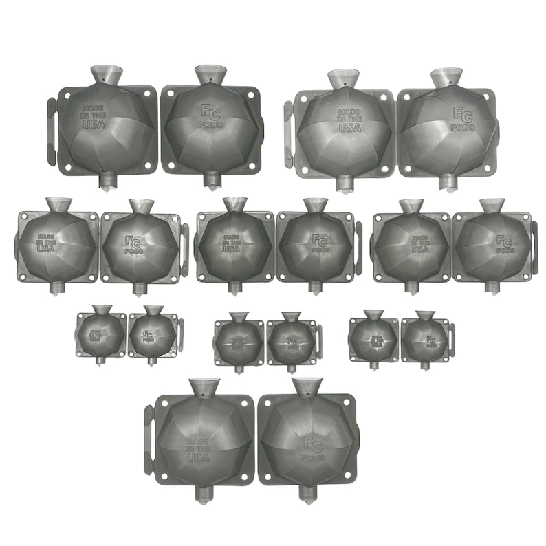 May include: A set of 14 gray metal molds for making ice cubes. The molds are shaped like a geometric diamond with a pointed top. The molds are arranged in rows and columns. The text "Made in the USA" and "FC P003" is printed on the molds.