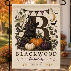 May include: A rectangular garden flag featuring a large letter B, a black cat wearing a witch hat, pumpkins, and floral motifs. The text reads BLACKWOOD family EST. 2018. The design includes a moth, bats, a crescent moon, and a bunting banner.