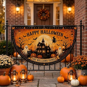 May include: A semi-circular Halloween banner featuring a haunted house, ghosts, pumpkins, and a witch silhouette against a full moon. The text reads Happy Halloween and The Williams Family. The banner is displayed on a black metal porch railing.
