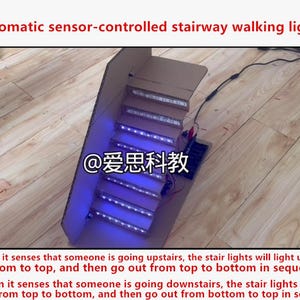 May include: A cardboard model of a staircase featuring automatic sensor-controlled LED strips on each step that emit a blue light. The model includes a small electronic control board and wiring, with the text "Automatic sensor-controlled stairway walking lights" displayed at the top.