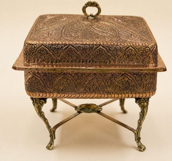 A fully hand-engraved brass trinket chest on cabriole legs — the kind of heirloom-quality object that looks like it escaped a Victorian antique shop.