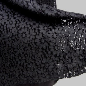 May include: Black lace fabric with a floral pattern.