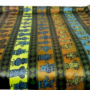 May include: Rolled fabric with a repeating pattern of stylized figures in vertical stripes. The stripes alternate between orange, blue, and yellow-green, with black diamond and olive green accents. The figures are in black and blue.