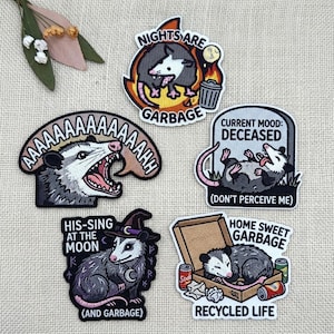 May include: Five embroidered patches featuring opossums with various designs and text including Nights Are Garbage, AAAAAAAAH, Current Mood: Deceased, His-Sing At The Moon, and Home Sweet Garbage Recycled Life with illustrations of trash and cans.