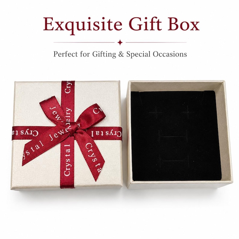 May include: A square beige gift box with a dark red ribbon tied in a bow, featuring the text "Crystal Jewelry" printed on the ribbon. Beside it is an open box with a black velvet insert containing slots for jewelry, with the text "Exquisite Gift Box" above.