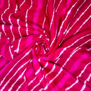 May include: A vibrant fuchsia and hot pink fabric featuring a repeating pattern of vertical, wavy white stripes. The material is gathered in a central spiral, creating dynamic folds and shadows that emphasize the bright, saturated color palette.