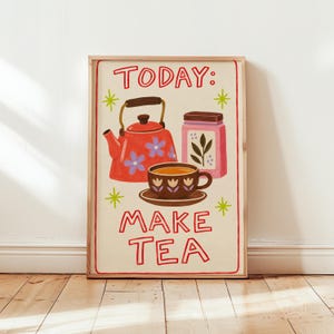 May include: A rectangular wall art print featuring a red teapot with blue flowers, a pink tea canister, and a brown teacup on a saucer. The text reads TODAY: MAKE TEA in red letters, accented by green star-shaped symbols on a cream background.
