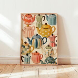 May include: A framed art print featuring a collection of colourful teapots and moka pots in various patterns including stripes, polka dots, and checkers. The illustration displays a variety of shapes and sizes in shades of orange, yellow, blue, and pink.