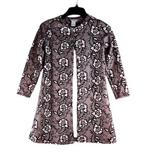 May include: A long-sleeved, open-front cardigan with a floral lace pattern in black and pink.