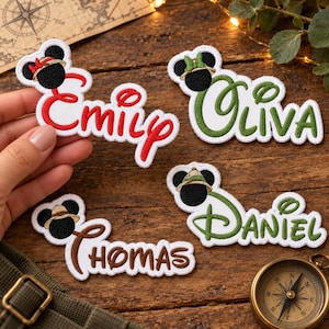 May include: Four embroidered fabric patches featuring black mouse-ear silhouettes with coloured hats and names written in cursive script. The patches display the names Emily in red, Olivia in green, Thomas in brown, and Daniel in green on white backgrounds.