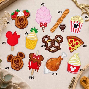 May include: A collection of twelve embroidered patches featuring food items including a Mickey-shaped waffle, cotton candy, churro, popcorn, popsicle, pineapple soft serve, pretzel, pizza slice, Mickey-shaped cookie, candy apple, turkey leg, and soft serve.