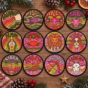 May include: A set of twelve circular patches featuring colorful illustrations of the zodiac signs: Aquarius, Pisces, Aries, Taurus, Gemini, Cancer, Leo, Virgo, Libra, Scorpio, Sagittarius, and Capricorn, each with its name printed in bold letters.