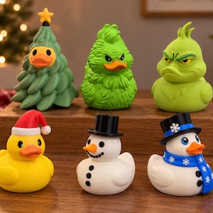 May include: A collection of six rubber ducks featuring holiday themes. The top row includes a green Christmas tree duck, a fuzzy green duck, and a grumpy green duck. The bottom row features a yellow duck with a Santa hat, a white snowman duck, and a white snowman duck with a blue scarf.