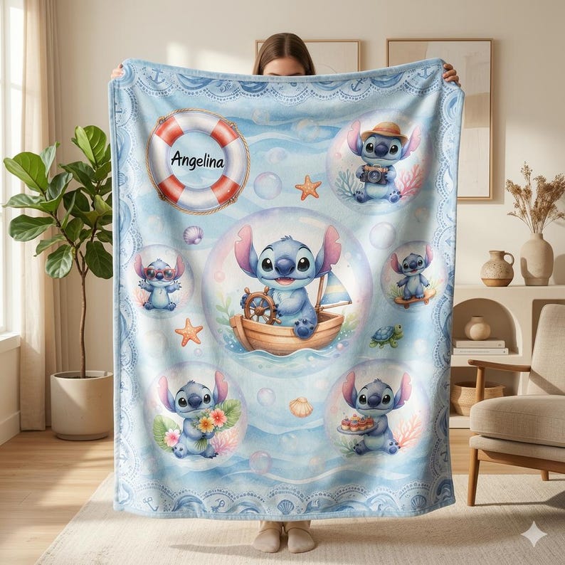 May include: A light blue fleece blanket featuring a repeating pattern of Stitch in bubbles, including scenes of Stitch in a boat, holding flowers, and wearing a hat. A red and white life preserver with the name Angelina is printed on the top left.
