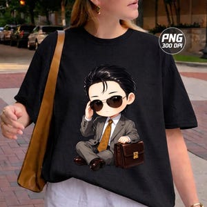 May include: A black t-shirt featuring a graphic of a chibi-style character with dark hair, wearing a grey suit, a gold tie, and dark sunglasses, while sitting and holding a brown briefcase. The graphic includes the text PNG 300 DPI in the corner.