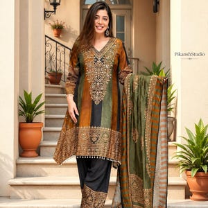 May include: A long-sleeved tunic featuring a V-neckline with intricate gold embroidery, paired with black trousers and a matching olive and brown striped shawl. The tunic displays vertical colour-blocked panels in black, olive, and brown tones.