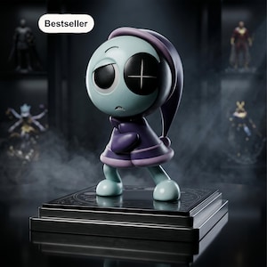 May include: A stylized figurine of a pale blue character with a large round head, wearing a dark purple hooded cloak and a matching nightcap. The character has one solid black eye and one eye with a white cross, standing on a square black base.