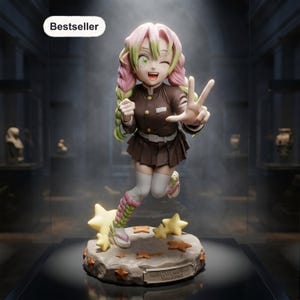 May include: A Mitsuri Kanroji anime figurine featuring pink and green hair, a dark brown uniform, and white thigh-high socks. The character is posed with one hand making a peace sign, standing on a circular base decorated with yellow and orange stars.