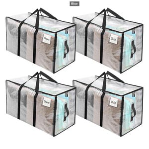 May include: Four rectangular clear storage bags with black trim, black handles, and black zips. Each bag features a small white label pocket on the front. Two bags are labelled Sheet and two bags are labelled Quilt in black text.