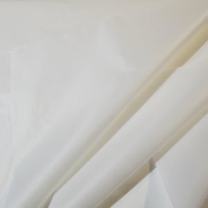 May include: A close-up of a white fabric with a smooth, silky texture. The fabric is folded in a way that shows its drape and sheen.