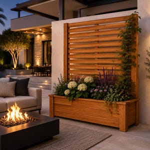 May include: A rectangular wooden planter box featuring a tall, slatted privacy screen back panel. The planter is filled with white hydrangea flowers, purple salvia, and green climbing vines, creating a natural vertical garden display.