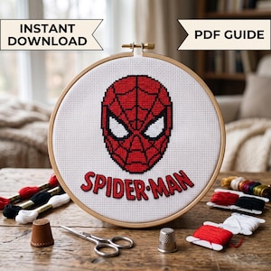 May include: A cross-stitch project in a round wooden hoop featuring the red and black Spider-Man mask and the text SPIDER-MAN on white Aida cloth. The image includes the text INSTANT DOWNLOAD and PDF GUIDE, with embroidery floss and scissors.