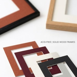 May include: A collection of solid wood frames and acid-free mat boards in various colors including terracotta, burgundy, cream, black, and light gray. The text ACID-FREE | SOLID WOOD FRAMES and NEUTRAL pH, 100% ACID-FREE is visible on the image.