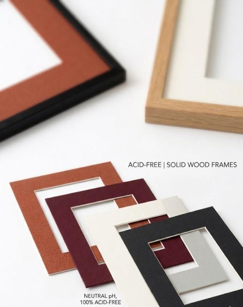 May include: A collection of solid wood frames and acid-free mat boards in various colors including terracotta, burgundy, cream, black, and light gray. The text ACID-FREE | SOLID WOOD FRAMES and NEUTRAL pH, 100% ACID-FREE is visible on the image.