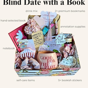 May include: A gift box titled Blind Date with a Book containing a hand-selected book, a notebook, a pink mug with the text GOOD FOR THE PLOT, drink mix, premium bookmarks, annotation supplies, self-care items, and bookish stickers.
