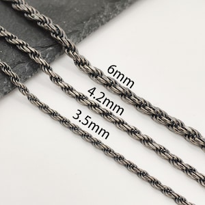 May include: Three dark silver-toned rope chains arranged diagonally, labelled with their respective widths of 3.5mm, 4.2mm, and 6mm. The chains feature a twisted, textured metal link design with a darkened, oxidised finish throughout the metal surface.