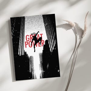 May include: A rectangular art print featuring a black silhouette of a figure leaping between tall city buildings. The text WITH GREAT POWER is printed in bold red capital letters across the center against a bright white background.