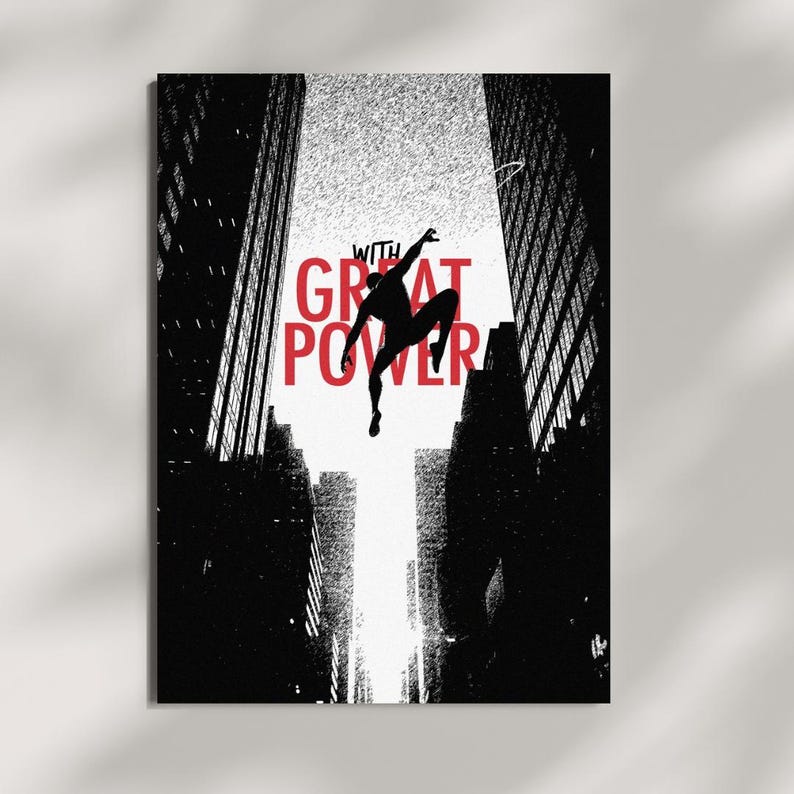 May include: A black and white graphic art print featuring a silhouette of a figure leaping between two tall city skyscrapers. The text WITH GREAT POWER is printed in bold red capital letters in the center of the composition against a white sky.