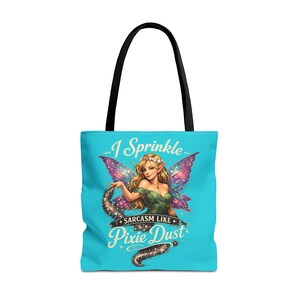 May include: A bright turquoise tote bag with black handles featuring a graphic of a blonde fairy with purple wings. The text reads I Sprinkle SARCASM LIKE Pixie Dust in a decorative font, accompanied by a trail of sparkling glitter and stars.