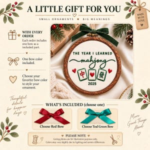 May include: A round wooden embroidery hoop ornament featuring white fabric with green embroidered text reading THE YEAR I LEARNED mahjong, three mahjong tiles, and the year 2025. A dark green velvet bow is attached to the top of the hoop.