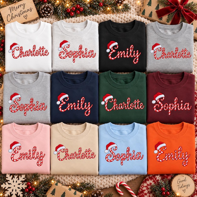 May include: A collection of twelve crewneck sweatshirts in various colors including white, gray, black, navy, dark green, maroon, pink, beige, light blue, and orange. Each sweatshirt features a name embroidered in a candy cane pattern.