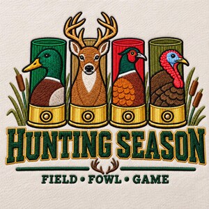 May include: An embroidered design featuring four shotgun shells containing a mallard, a deer, a pheasant, and a turkey. The text reads HUNTING SEASON and FIELD FOWL GAME. The design includes cattails and deer antlers on a light fabric background.